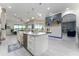 Spacious open kitchen with a large island, white cabinetry, and a stylish modern fireplace at 1111 Myrtle Breezes Ct, Fruitland Park, FL 34731