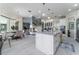 Bright kitchen featuring a large center island, modern appliances, and access to the living room at 1111 Myrtle Breezes Ct, Fruitland Park, FL 34731