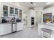 Dry bar with white cabinets, stainless steel appliances, and adjacent to the kitchen at 1111 Myrtle Breezes Ct, Fruitland Park, FL 34731