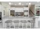 Bright kitchen featuring a large center island with seating, modern appliances, and tile backsplash at 1111 Myrtle Breezes Ct, Fruitland Park, FL 34731