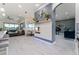 Bright open-concept living room with modern fireplace, island seating, and beautiful lake views at 1111 Myrtle Breezes Ct, Fruitland Park, FL 34731