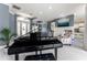 Elegant living room featuring a grand piano and stylish decor, creating a sophisticated ambiance at 1111 Myrtle Breezes Ct, Fruitland Park, FL 34731