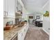 Spacious living room with carpet flooring, a bar area, and comfortable leather seating at 1111 Myrtle Breezes Ct, Fruitland Park, FL 34731