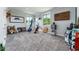 Spacious living room with carpet flooring, taxidermy, and American flag decor at 1111 Myrtle Breezes Ct, Fruitland Park, FL 34731