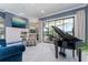 Open living area featuring tiled floors, fireplace, and a piano with outdoor views at 1111 Myrtle Breezes Ct, Fruitland Park, FL 34731
