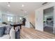 Bright living room with beautiful laminate flooring, plush sofas, and an elegant billiards table at 1111 Myrtle Breezes Ct, Fruitland Park, FL 34731