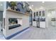 Modern fireplace with blue led lighting, and a dry bar with white cabinets at 1111 Myrtle Breezes Ct, Fruitland Park, FL 34731