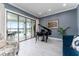 Elegant living room featuring tiled floors, a piano, and large sliding glass doors at 1111 Myrtle Breezes Ct, Fruitland Park, FL 34731