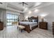 Spacious main bedroom with tray ceilings and a view of the outdoor living space and pool at 1111 Myrtle Breezes Ct, Fruitland Park, FL 34731