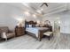 Bright main bedroom features a decorative tray ceiling, neutral walls, and beautiful wood furniture at 1111 Myrtle Breezes Ct, Fruitland Park, FL 34731