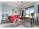 Comfortable home office with red sofa, desk, and scenic golf course view at 1111 Myrtle Breezes Ct, Fruitland Park, FL 34731