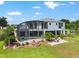 Landscaped backyard featuring a screened pool and comfortable patio seating, ideal for relaxing or entertaining outdoors at 1111 Myrtle Breezes Ct, Fruitland Park, FL 34731