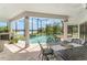 A screened-in pool area with a spa and a table for outdoor dining create a relaxing oasis at 1111 Myrtle Breezes Ct, Fruitland Park, FL 34731