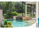 This spa area with water feature complements the screened-in pool, and is perfect for relaxation at 1111 Myrtle Breezes Ct, Fruitland Park, FL 34731