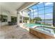 The screened in pool and spa area with lake views creates a resort style outdoor oasis at 1111 Myrtle Breezes Ct, Fruitland Park, FL 34731
