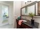 Well-lit powder room with a dark wood vanity, large mirror, and outdoor access at 1111 Myrtle Breezes Ct, Fruitland Park, FL 34731