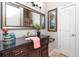 Stylish powder room featuring dark wood vanity, large mirror, and decorative accents at 1111 Myrtle Breezes Ct, Fruitland Park, FL 34731