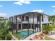 The house features a screened-in pool area, blending indoor and outdoor living with palm trees and tropical plants at 1111 Myrtle Breezes Ct, Fruitland Park, FL 34731