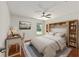 Bedroom features wood floors, natural light, a ceiling fan, and a built-in bookcase at 1329 Gaston Loop, The Villages, FL 32162