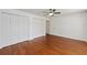 An empty bedroom with hardwood floors, white walls, and closet at 1329 Gaston Loop, The Villages, FL 32162