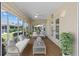 Enclosed sun room with plenty of natural light and cozy seating area at 1329 Gaston Loop, The Villages, FL 32162
