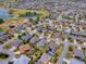 An aerial view of a lovely home in a golf course community with mature landscaping and well-maintained streets at 1454 Neuport Path, The Villages, FL 32163