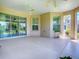 This screened lanai boasts sliding doors into the home and large windows offering great natural light at 1454 Neuport Path, The Villages, FL 32163