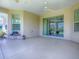 Enjoy this spacious lanai featuring neutral color scheme, ceiling fan, and sliding glass doors to patio at 1454 Neuport Path, The Villages, FL 32163