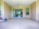 Enjoy this spacious patio featuring neutral color scheme, ceiling fan, and sliding glass doors to lanai at 1454 Neuport Path, The Villages, FL 32163