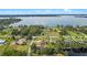 Captivating aerial perspective of the property, beautifully situated near the tranquil lake and natural greenery at 16200 E Shirley Shores Rd, Tavares, FL 32778