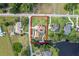 Aerial view showcasing property boundaries, lush landscaping, RV parking and proximity to waterway at 16200 E Shirley Shores Rd, Tavares, FL 32778