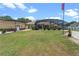 This spacious backyard features a screened pool, a storage shed, and a lush green lawn at 16200 E Shirley Shores Rd, Tavares, FL 32778