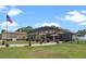 Expansive backyard with lush lawn, screened-in pool area, and well-maintained landscaping, perfect for outdoor enjoyment at 16200 E Shirley Shores Rd, Tavares, FL 32778