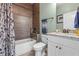 Bathroom with white cabinets, granite countertops, modern fixtures, and a tiled shower/tub at 16200 E Shirley Shores Rd, Tavares, FL 32778