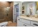 Well-appointed bathroom featuring granite countertop vanity, updated faucet, tile flooring, and glass-enclosed shower at 16200 E Shirley Shores Rd, Tavares, FL 32778