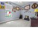 Decorated bedroom featuring light-grey walls, carpet, window and unique wall art at 16200 E Shirley Shores Rd, Tavares, FL 32778