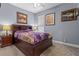 Cozy bedroom featuring a comfortable bed, classic decor, and ample natural light at 16200 E Shirley Shores Rd, Tavares, FL 32778