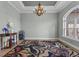 Classic dining room with elegant chandelier, stylish rug, and ample natural light at 16200 E Shirley Shores Rd, Tavares, FL 32778