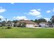 Beautiful home exterior with well-maintained lawn, ample parking, and garage, exuding suburban charm at 16200 E Shirley Shores Rd, Tavares, FL 32778