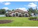 Stunning single-story home featuring a tile roof, well-manicured lawn, and lush landscaping at 16200 E Shirley Shores Rd, Tavares, FL 32778