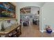 Inviting foyer with elegant console table, decor, and wood-look tile flooring leading to the kitchen and living area at 16200 E Shirley Shores Rd, Tavares, FL 32778