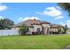 Charming home showcasing manicured lawn, elegant arched entryway, stone accents, and lush landscaping for curb appeal at 16200 E Shirley Shores Rd, Tavares, FL 32778
