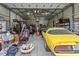 Spacious garage showcasing multiple parked cars, storage racks, and ample room for various projects at 16200 E Shirley Shores Rd, Tavares, FL 32778