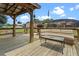 A wooden gazebo and lounge area creates a relaxing outdoor escape in the backyard at 16200 E Shirley Shores Rd, Tavares, FL 32778