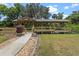 The backyard gazebo has an ornate wooden design and a paved walking path at 16200 E Shirley Shores Rd, Tavares, FL 32778