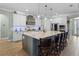 Gourmet kitchen with a large center island, pendant lighting, modern appliances, and white cabinetry at 16200 E Shirley Shores Rd, Tavares, FL 32778