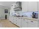This is a kitchen with white cabinets, stainless steel appliances, and granite countertops at 16200 E Shirley Shores Rd, Tavares, FL 32778