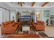 Stylish living room featuring comfortable leather sofas, a modern entertainment center, and unique decor at 16200 E Shirley Shores Rd, Tavares, FL 32778