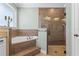 Spa-like bathroom features a tiled shower with glass door and separate soaking tub at 16200 E Shirley Shores Rd, Tavares, FL 32778