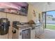 This outdoor kitchen has a built in grill, sink, stainless drawers and doors, and a television at 16200 E Shirley Shores Rd, Tavares, FL 32778